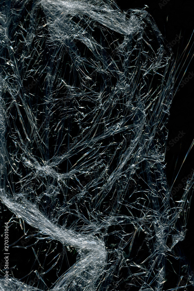 Transparent plastic wrap on the black background. Plastic bag texture. Reusable trash and waste. Transparent plastic wrap on the black background. Plastic bag texture. Reusable trash and waste.