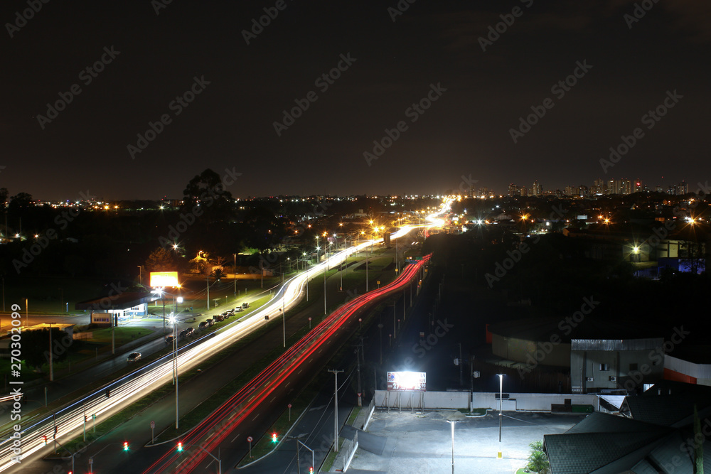 Fototapeta premium Time lapse photograph taken on top of a building in the city of Curitba