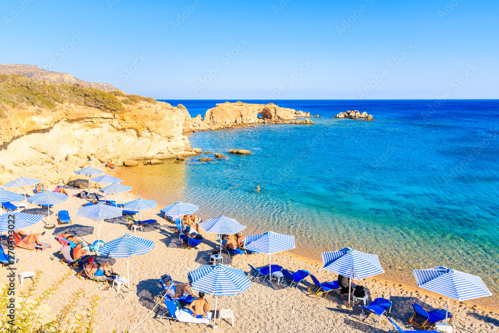 Φωτογραφία KARPATHOS ISLAND, GREECE - SEP 26, 2018: People relaxing on beautiful beach on Karpathos island near Ammopi village, Greece