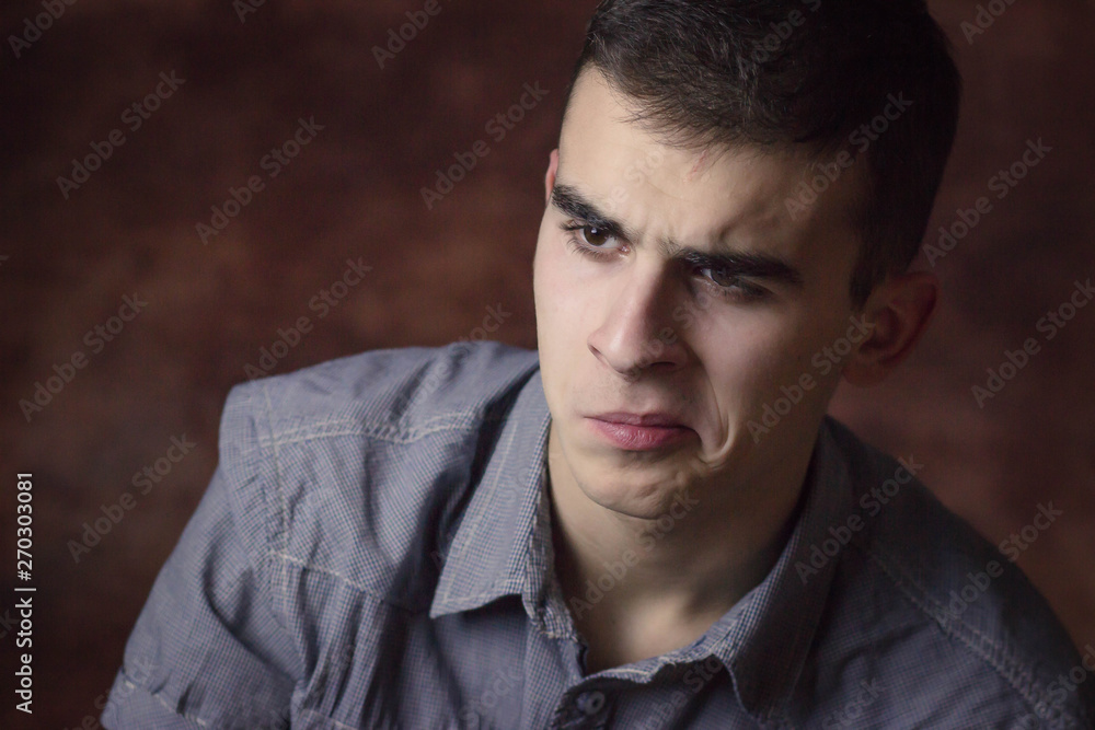 Fototapeta premium Closeup portrait confused young man. Human facial expression, body language