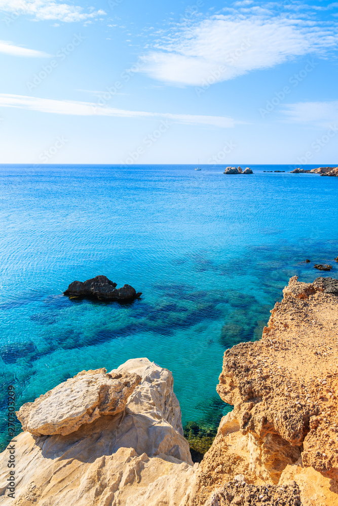 Rocks and azure sea in beautiful bay on Karpathos island in Ammopi village, Greece