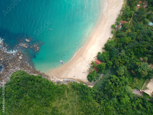 Fototapeta Naklejka Na Ścianę i Meble -  Aerial view of an amazing white sandy beach with turquoise water in tropical country. Amazing top view of sandy tropical beach. holiday destination. Palm and tropical beach with crystal clear water.