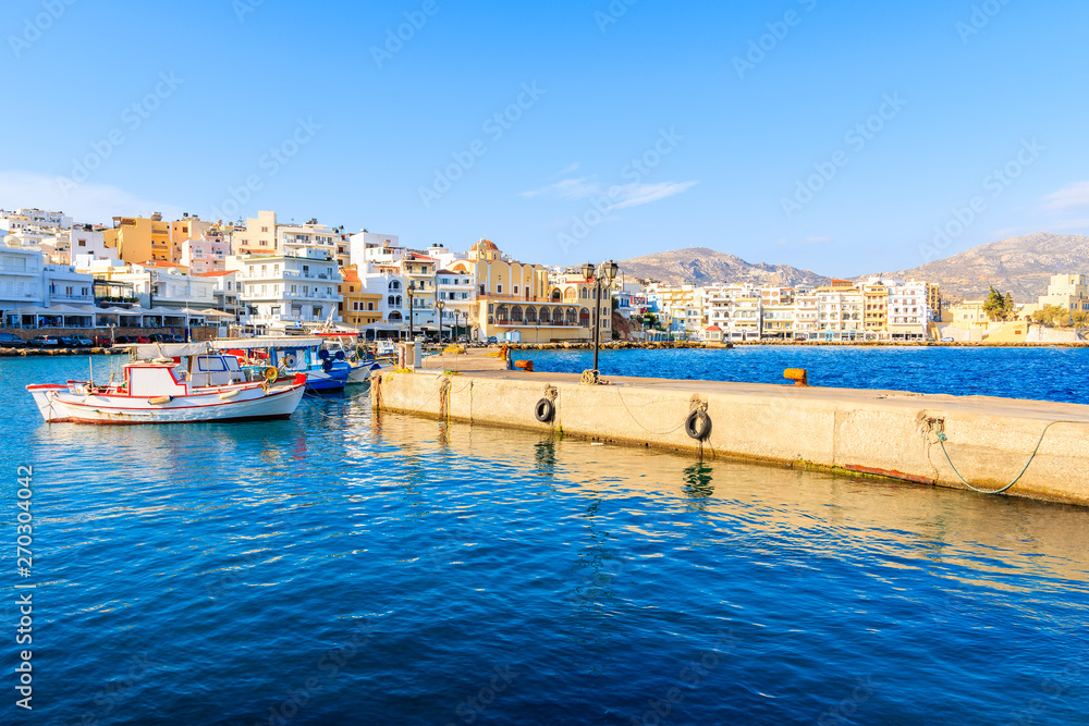 Boats in beautiful Pigadia fishing port with mountains in background, Karpathos island, Greece