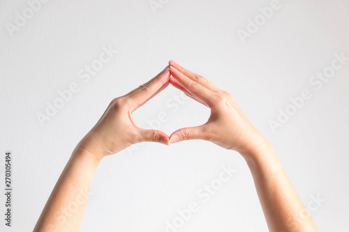Hands pose tip of fingers splice to be spade shape frame on white background.