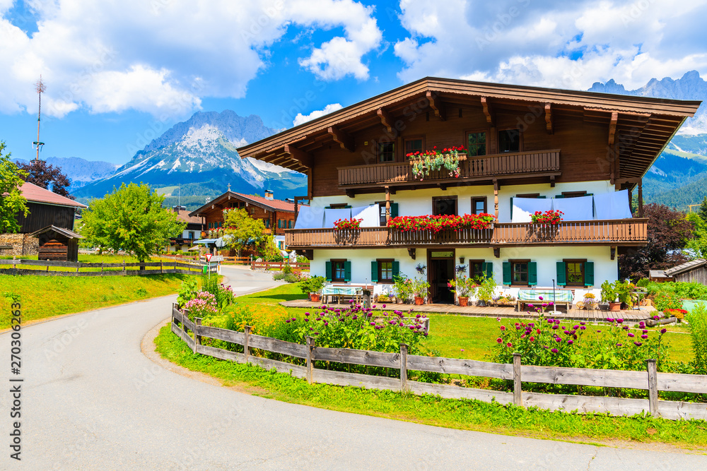 Traditional alpine house in village of Going am Wilden Kaiser on beautiful sunny summer day, Tirol, Austria Traditional alpine house in village of Going am Wilden Kaiser on beautiful sunny summer day, Tirol, Austria
