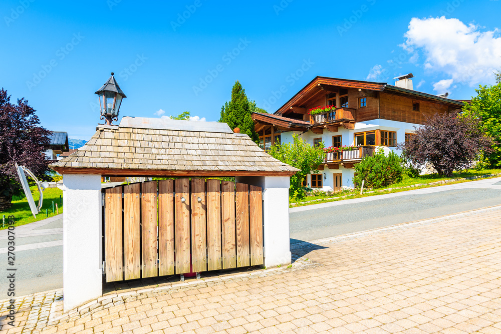 Road and traditional alpine houses in village of Going am Wilden Kaiser ...
