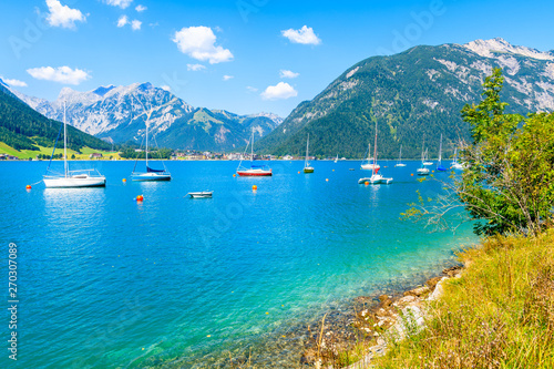 Sailing boats and view of beach near Pertisau town at beautiful Achensee lake on sunny summer day  Tirol  Austria