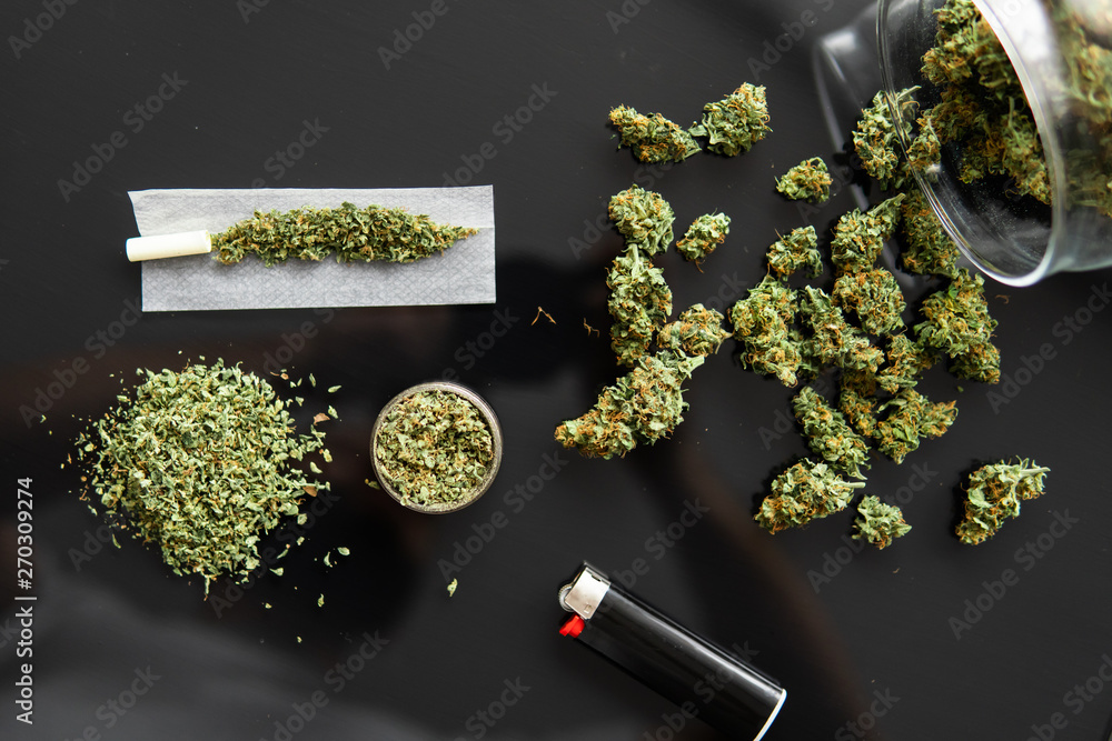 Weed grinder Fresh marihuana. Cannabis buds on white wood background. Copy  space. Close up. Blunt and Lighters. CBD and THC on buds in cannabis. Stock  Photo