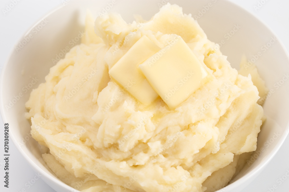 Potatoes with Butter Isolated on a Wooden Table Potatoes with Butter Isolated on a Wooden Table