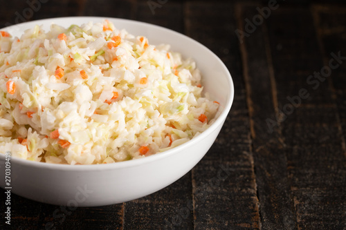Bowl of Coleslaw on a Rustic Wooden Table