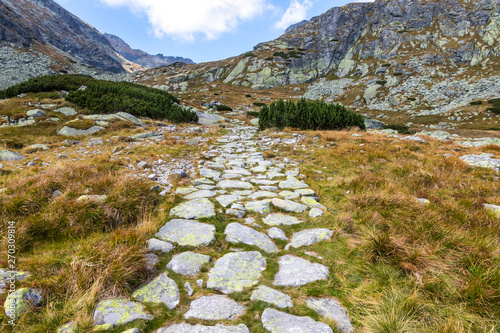 Hiking in High Tatras Mountains (Vysoke Tatry), Slovakia. Mlynicka Valley. Footpath on the way to Furkotsky Stit mount (2403m). Sunny autumn day photo