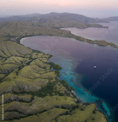 Seen from a bird's eye view, dawn breaks over scenic islands in Komodo National Park, Indonesia. This tropical area is known for its marine biodiversity as well as its dragons.