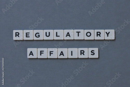 ' Regulatory Affairs ' word made of square letter word on grey background. photo