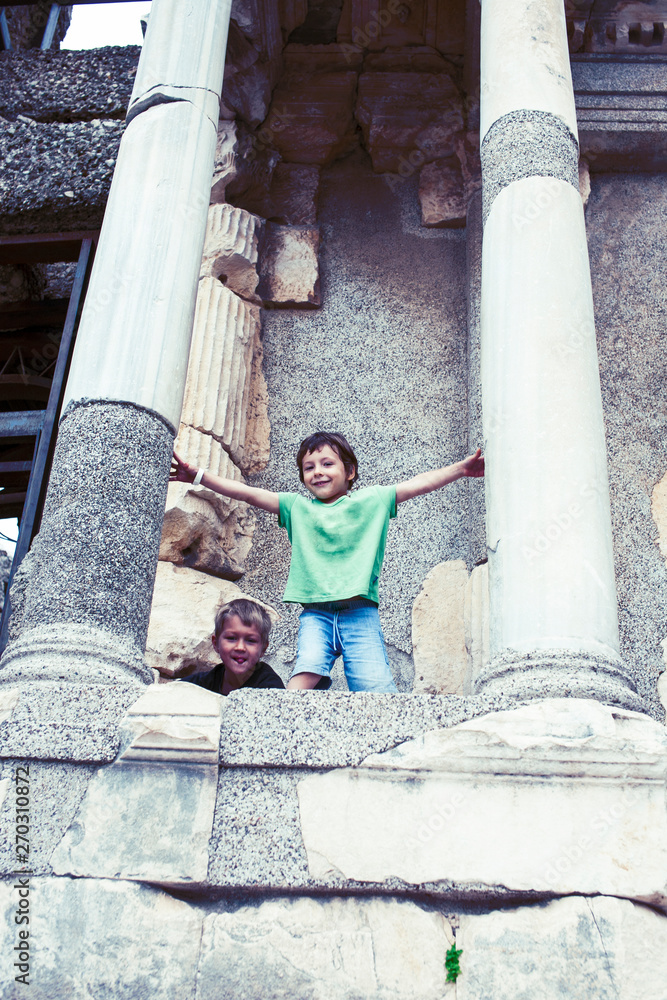 Fototapeta premium little boy exploring ancient architecture, lifestyle people on summer vacation close up