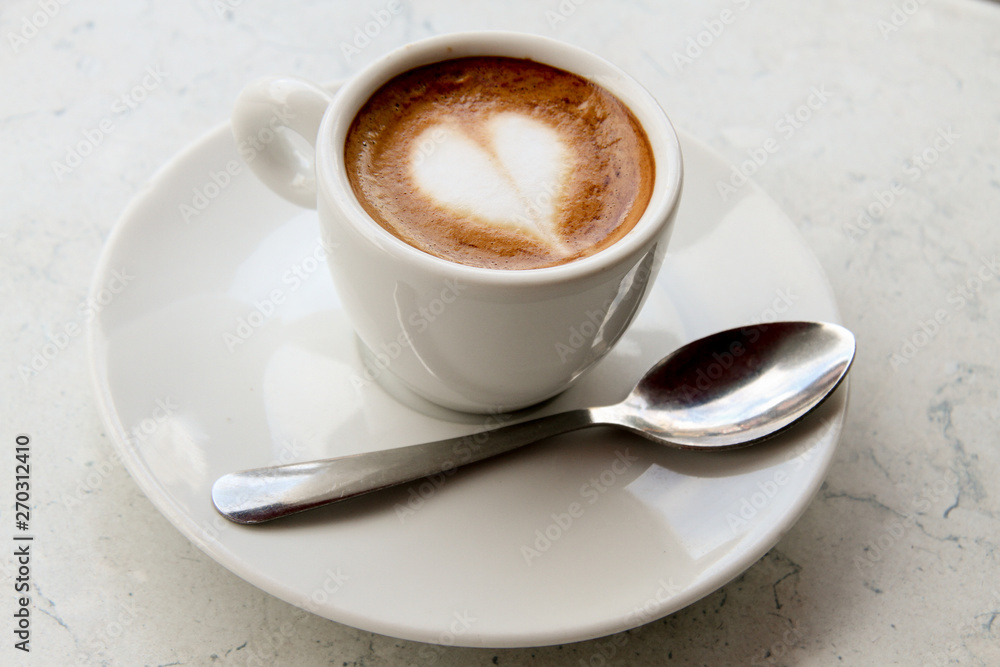 Cappuccino with white cup and saucer heart spoon Cappuccino with white cup and saucer heart spoon
