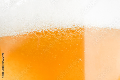 Close up beer bubble froth in glass celebration drink alcohol background