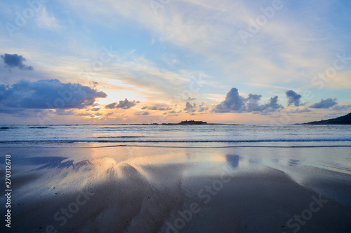 Beach of moledo at the end of the day, with a view to trega mountain on spanish side of the border. Low tide displaying the sandy beach on a cloudy day.