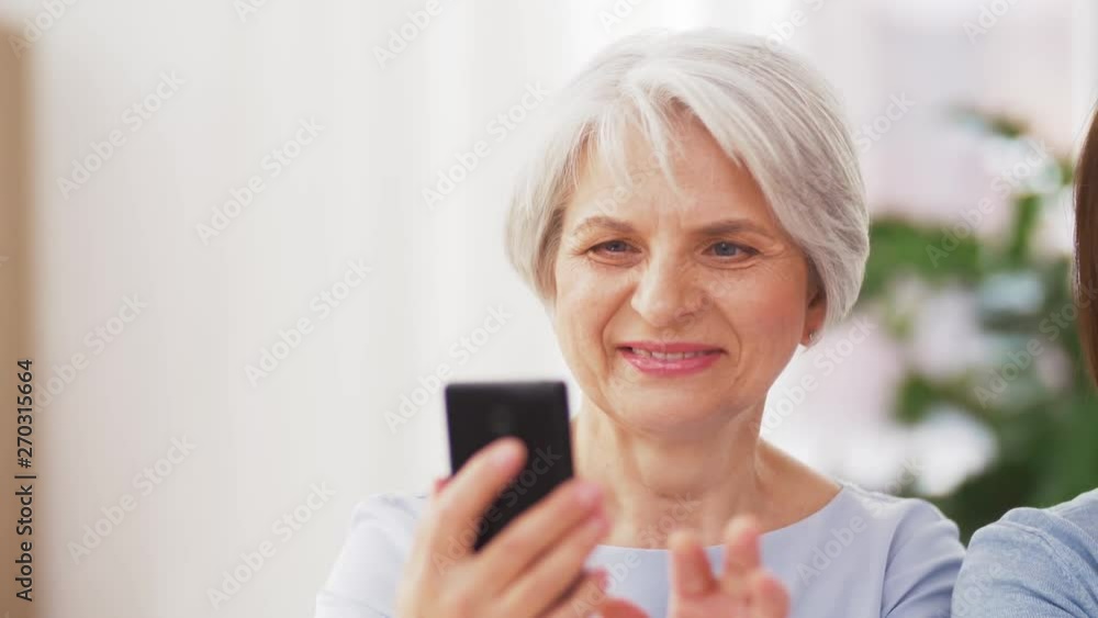 family, generation and people concept - portrait of senior mother and adult daughter with smartphone family, generation and people concept - portrait of senior mother and adult daughter with smartphone