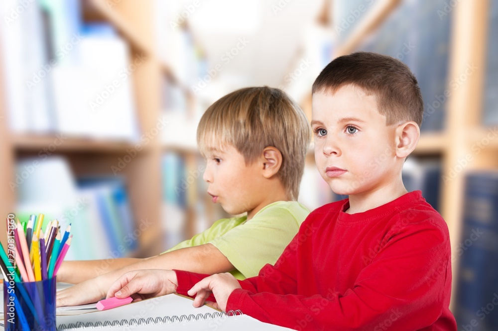 Two little boys studying subject on background Two little boys studying subject on background
