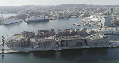 4K aerial with pan motion of the Oslo fjord, downtown Oslo and Bjoervika district, with the new Edvard Munch museum Lambda, Barcode quarter, Soerenga pier and Oslo Opera House. photo