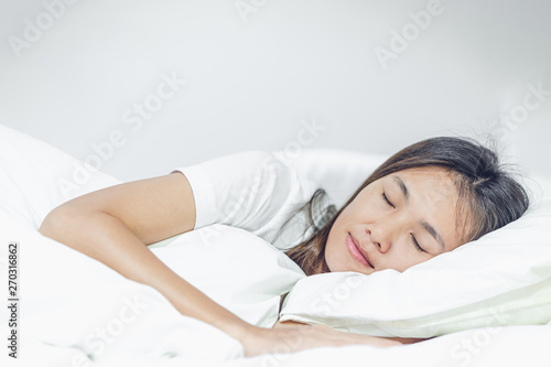 Beautiful young asian woman sleeping in bed.
