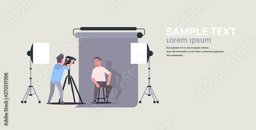 professional photographer using camera shooting business man model posing in modern photo studio interior horizontal full length flat copy space