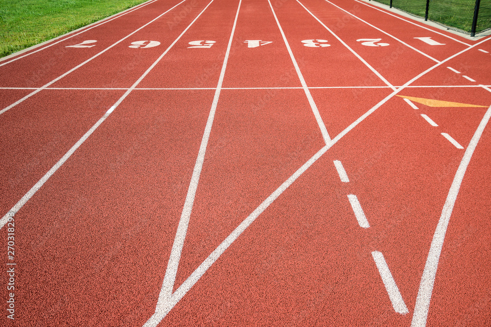 Red running track, track and field or athletics track start line with lane numbers
