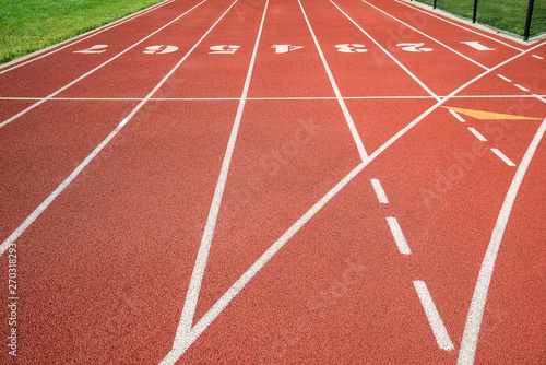 Red running track  track and field or athletics track start line with lane numbers
