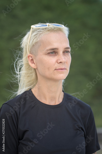 Portrait of a blonde girl on a background of nature.