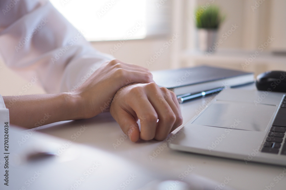 Fototapeta premium Businesswoman has a pain in her wrist from using the computer for a long time. Office syndrome