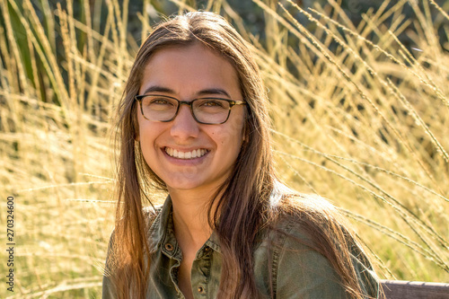 Young Multi-Ethnic Woman in Glasses Smiles on a Summer Day.