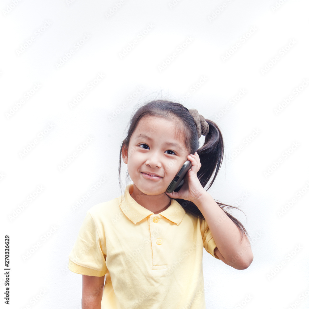 Cute little girl calling mobile phone. Kid hands hold smart phone.