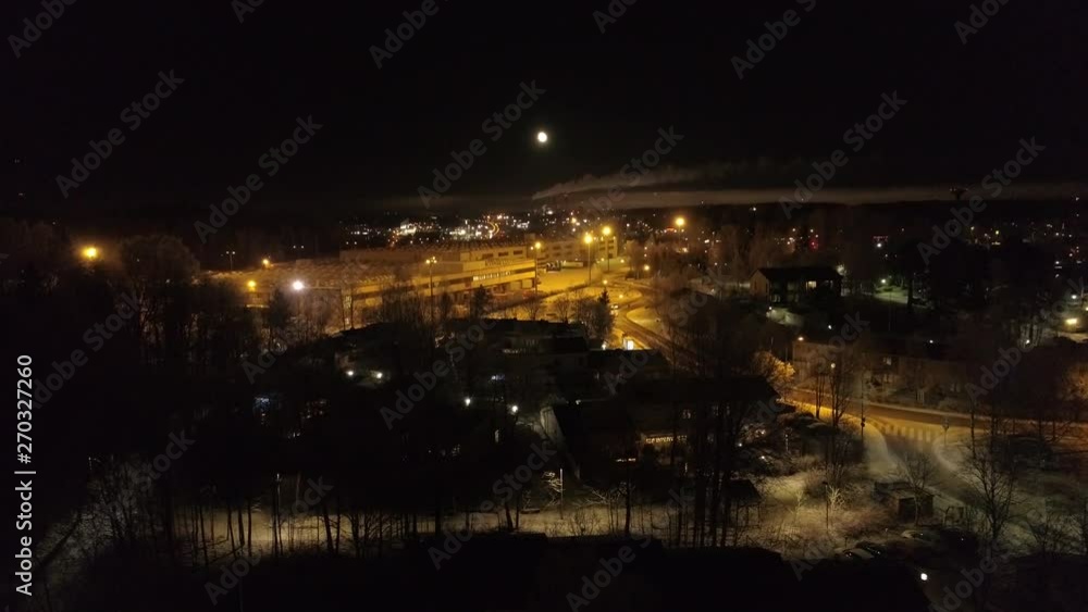 Revealing rise aerial shot of industrial suburban area in scandinavia by night Revealing rise aerial shot of industrial suburban area in scandinavia by night