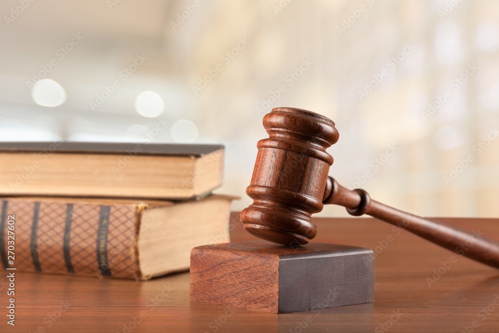 Judge hammer and documents on room background, bokeh background Judge hammer and documents on room background, bokeh background