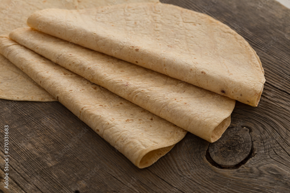 Lavash, tortilla, lavaş, flat and thin bread on table 