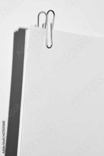 paper clip on white paper sheets close up