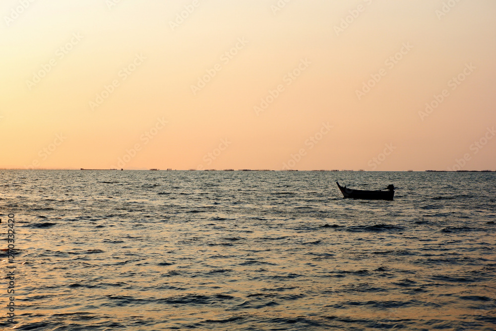 Small fishing boat concept Floating in the sea in the evening Small fishing boat concept Floating in the sea in the evening