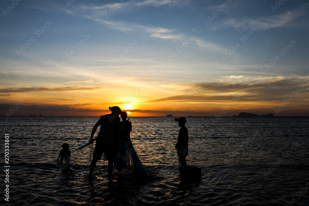 silhouette of fisherman family.