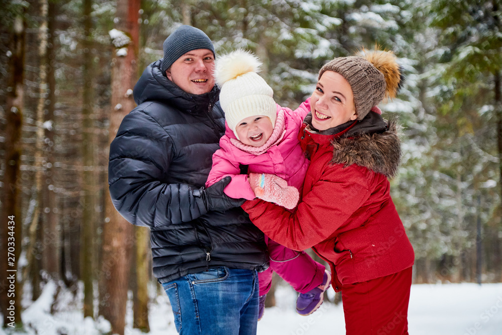 Ordinary family walking in a winter forest