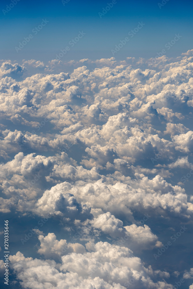 Naklejka premium White clouds and sky, a view from airplane window
