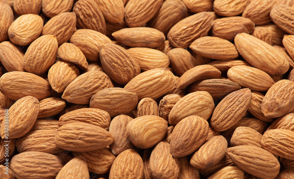 Background of raw peeled almonds. Heap of nuts Background of raw peeled almonds. Heap of nuts