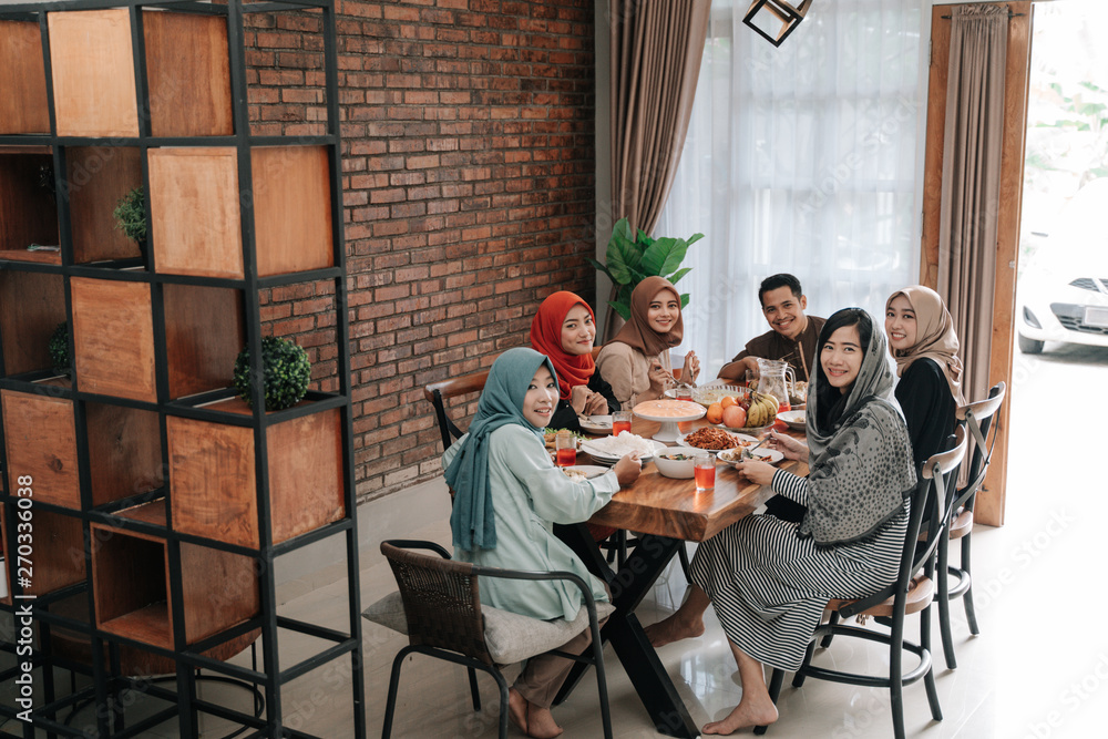 portrait of happy family look at camera together in the dining room when breaking fast