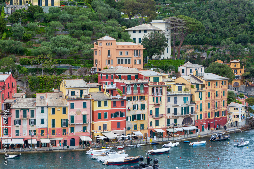 Portofino Italy. 04-29-2019.  Boats  and colored houses at Portofino, Italy