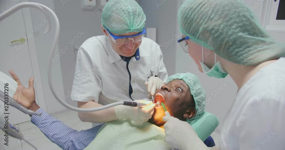 adult black patient is hysterical in dental chair adult black patient is hysterical in dental chair