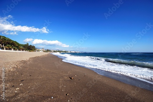 View along a quiet Daitona beach and coastline, Marbella, Spain. © arenaphotouk