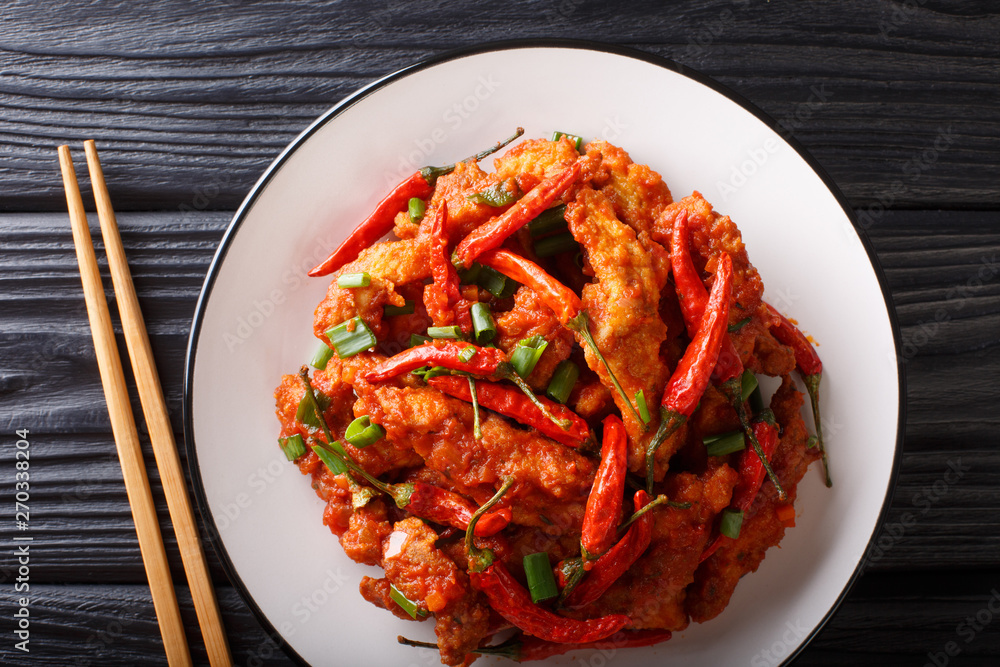Stir fry Schezwan chicken spicy sauce close-up on a plate. horizontal top view Stir fry Schezwan chicken spicy sauce close-up on a plate. horizontal top view