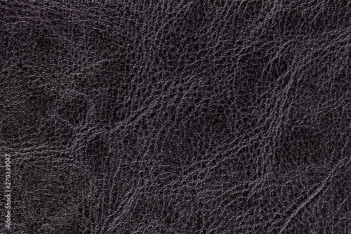 Dark gray leather texture background, closeup. Black cracked backdrop from wrinkle skin