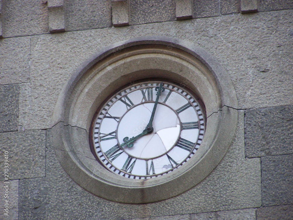 Fototapeta premium Background clock in the stone wall of the city