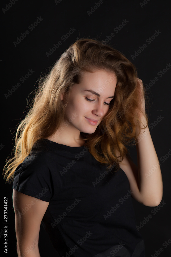 closeup portrait of a young, beautiful woman on a black background closeup portrait of a young, beautiful woman on a black background