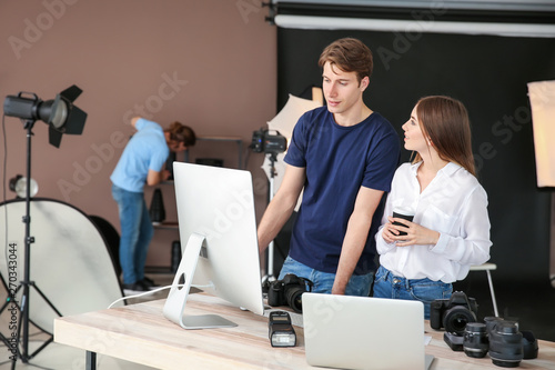 Professional photographers working in modern studio
